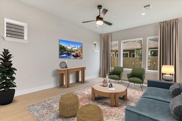 living area featuring a ceiling fan, wood finished floors, baseboards, and recessed lighting