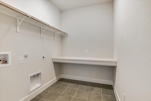 laundry area with electric dryer hookup, dark tile patterned flooring, gas dryer hookup, baseboards, and hookup for a washing machine