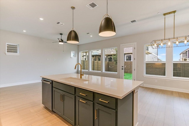 kitchen featuring a sink, dishwasher, plenty of natural light, hanging light fixtures, and recessed lighting