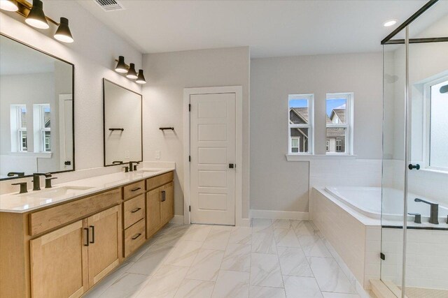 full bath with a stall shower, double vanity, marble finish flooring, and a bath