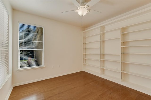 spare room with ceiling fan, baseboards, and wood finished floors