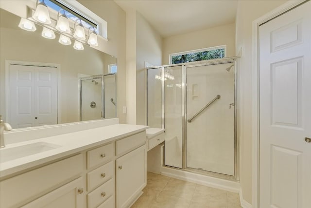 full bathroom with a closet, a shower stall, vanity, and tile patterned floors