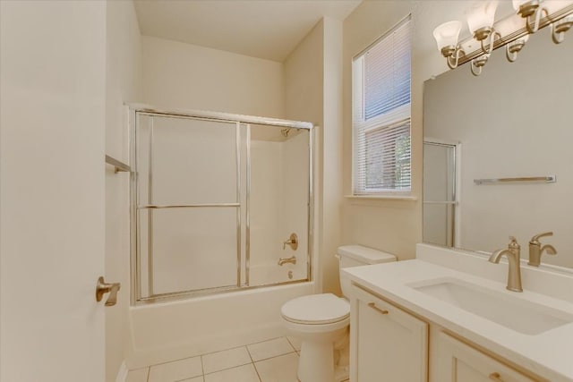 full bath with toilet, vanity, bath / shower combo with glass door, and tile patterned floors