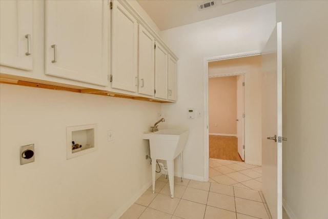 clothes washing area featuring cabinet space, light tile patterned floors, visible vents, hookup for an electric dryer, and washer hookup