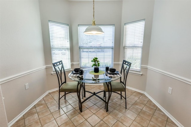 dining room featuring baseboards and light tile patterned flooring