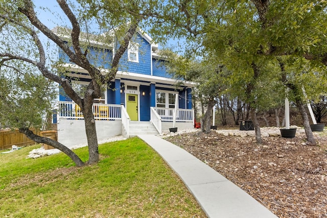 view of front facade with a front lawn and a porch