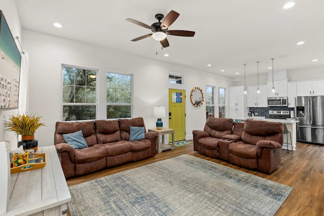 living area with ceiling fan, wood finished floors, and recessed lighting