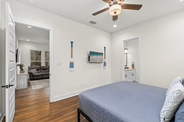 bedroom with visible vents, baseboards, dark wood-style floors, ensuite bath, and recessed lighting