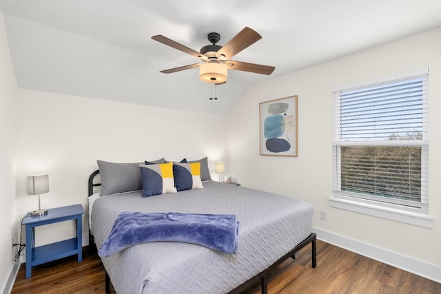 bedroom featuring a ceiling fan, vaulted ceiling, dark wood finished floors, and baseboards