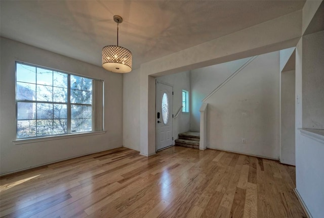 foyer featuring light wood finished floors and stairs