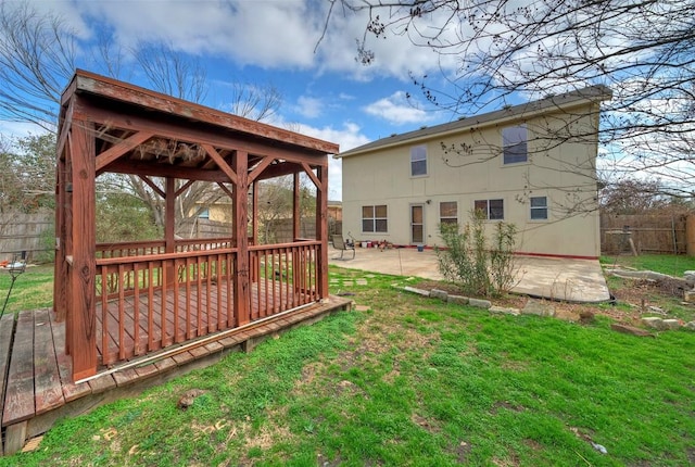 view of yard featuring a fenced backyard, a wooden deck, a patio, and a gazebo