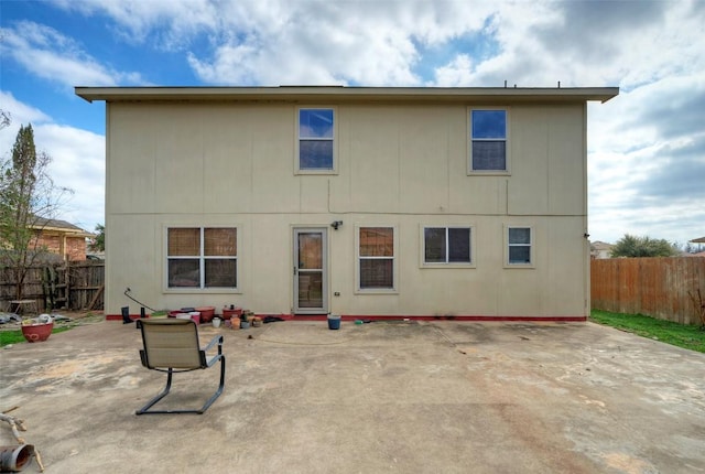 back of house featuring a patio area and a fenced backyard