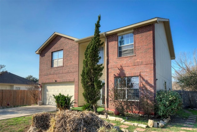 traditional-style home featuring fence, concrete driveway, and brick siding