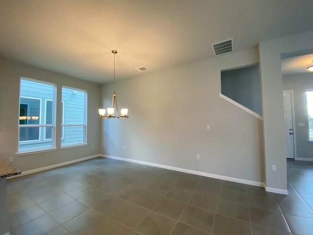 320 Creek Rd Unit 303, Dripping Springs, TX 78620 - unfurnished dining area featuring a chandelier, dark tile patterned flooring, and baseboards