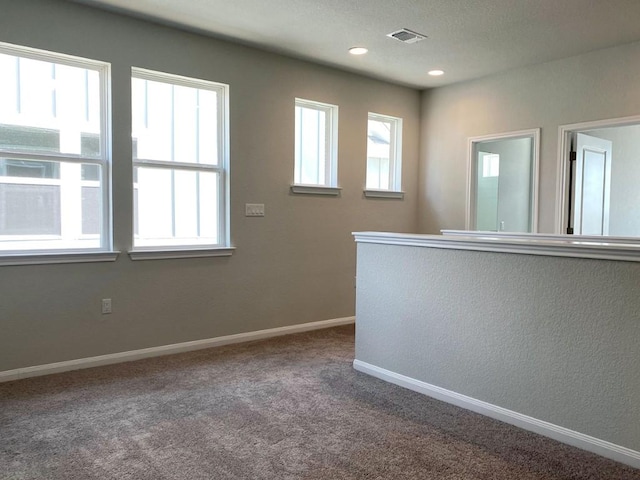 carpeted empty room with recessed lighting, visible vents, plenty of natural light, and baseboards