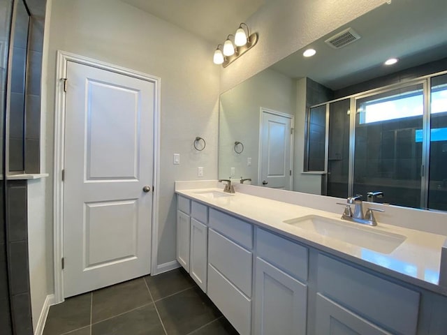 320 Creek Rd Unit 303, Dripping Springs, TX 78620 - bathroom with tile patterned floors, double vanity, a shower stall, and baseboards