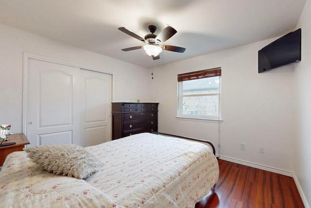 bedroom featuring dark wood-style floors, a closet, a ceiling fan, and baseboards