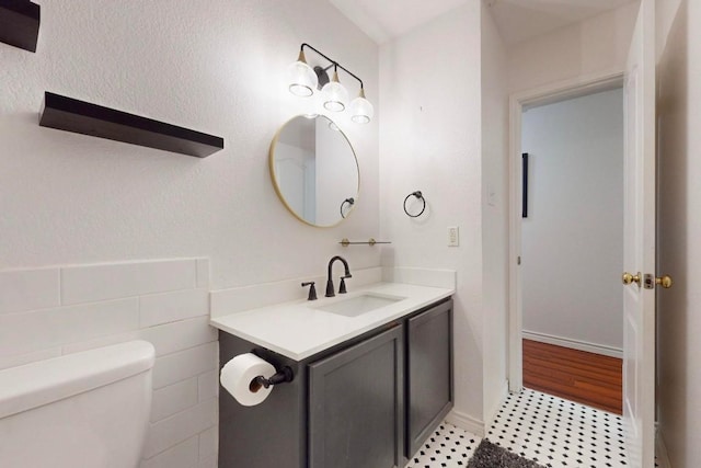 bathroom featuring tile patterned flooring, vanity, and toilet