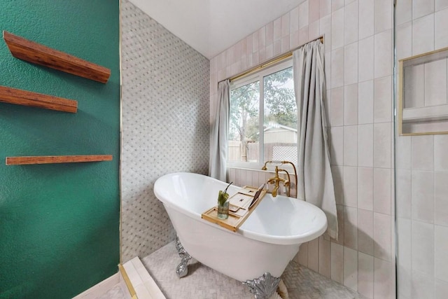 full bath with a freestanding tub and tiled shower