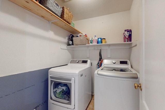 laundry room with washer and dryer and laundry area