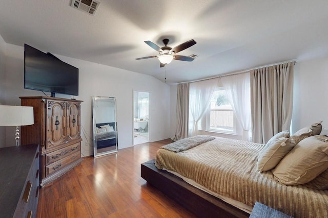 bedroom featuring lofted ceiling, wood finished floors, visible vents, and ceiling fan