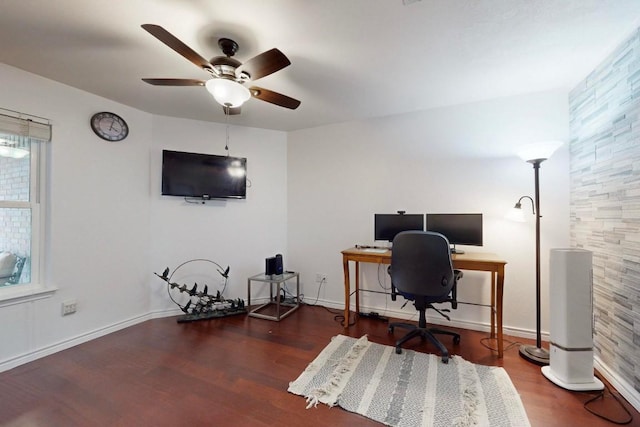 home office featuring ceiling fan, dark wood-style flooring, and baseboards