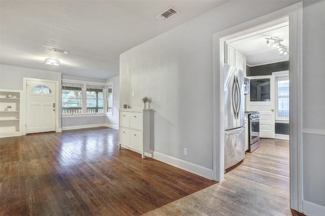 entryway featuring baseboards, visible vents, and dark wood-style flooring