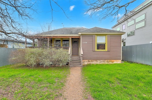 view of front of house featuring a front yard and fence