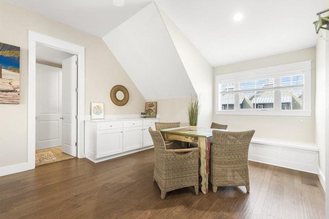 dining area featuring baseboards, vaulted ceiling, and dark wood-style flooring