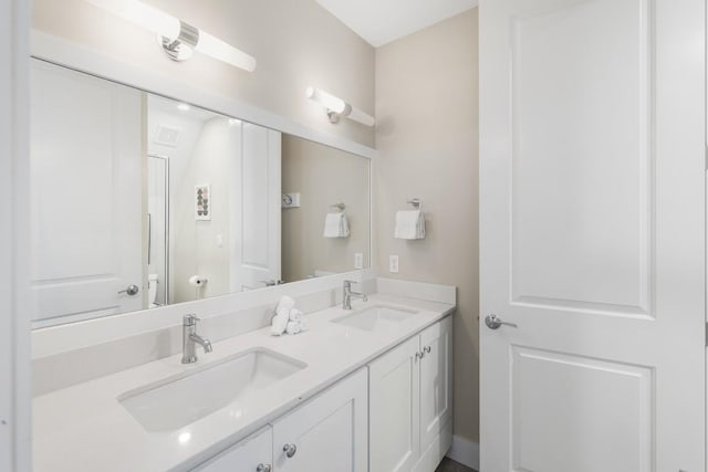 bathroom featuring double vanity and a sink