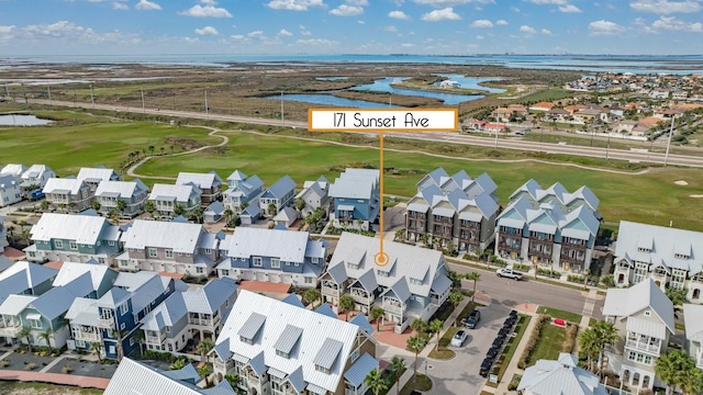 aerial view featuring golf course view, a water view, and a residential view