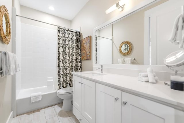 bathroom featuring toilet, tile patterned floors, shower / bath combo with shower curtain, and vanity