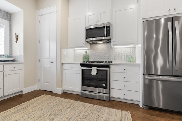 kitchen with stainless steel appliances, tasteful backsplash, light countertops, and white cabinetry