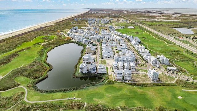 birds eye view of property featuring a water view, view of golf course, and a view of the beach