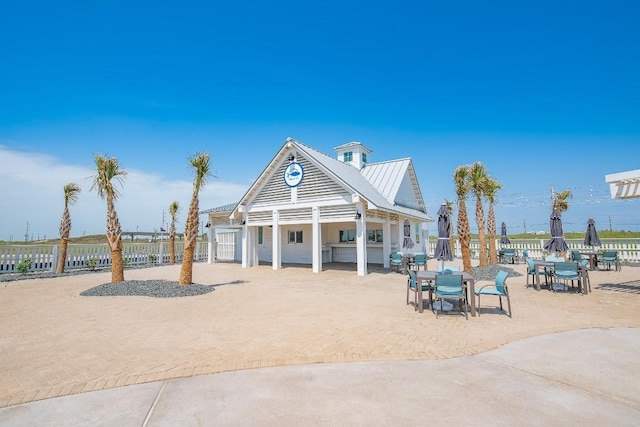 view of property's community featuring a patio and fence