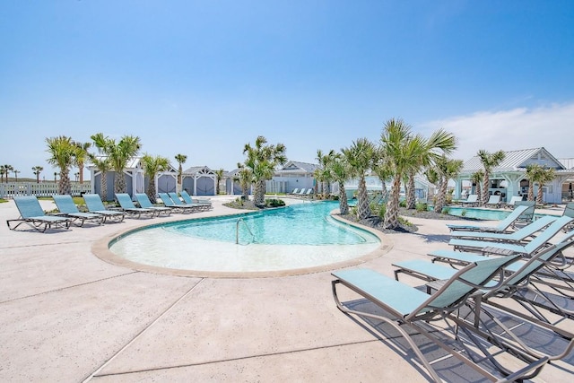 pool featuring fence and a patio