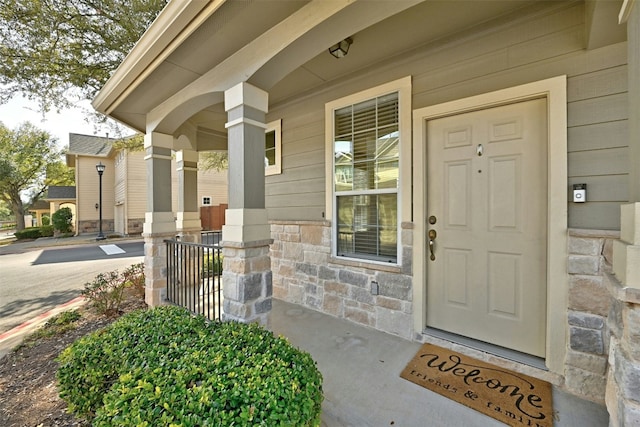 11000 Anderson Mill Rd Unit 52, Austin, TX 78750 - doorway to property featuring covered porch and stone siding