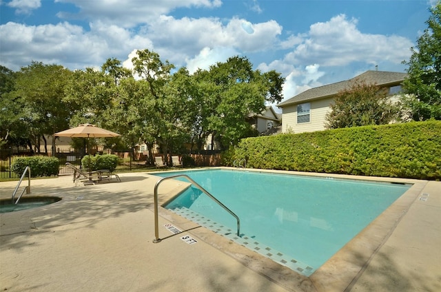 community pool featuring a patio area and fence