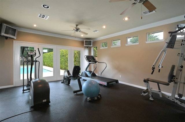 workout area featuring plenty of natural light, visible vents, baseboards, and ornamental molding