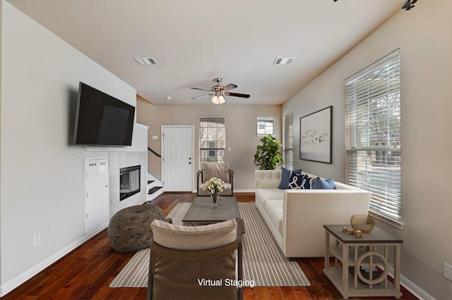 11000 Anderson Mill Rd Unit 52, Austin, TX 78750 - living area featuring a tile fireplace, baseboards, wood-type flooring, and ceiling fan