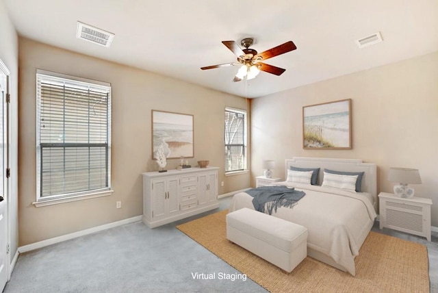 11000 Anderson Mill Rd Unit 52, Austin, TX 78750 - bedroom featuring multiple windows, baseboards, light carpet, and a ceiling fan