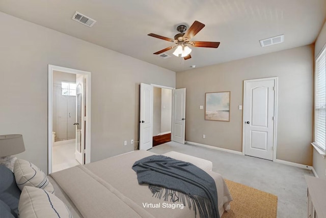 11000 Anderson Mill Rd Unit 52, Austin, TX 78750 - bedroom with light colored carpet, baseboards, multiple windows, and connected bathroom