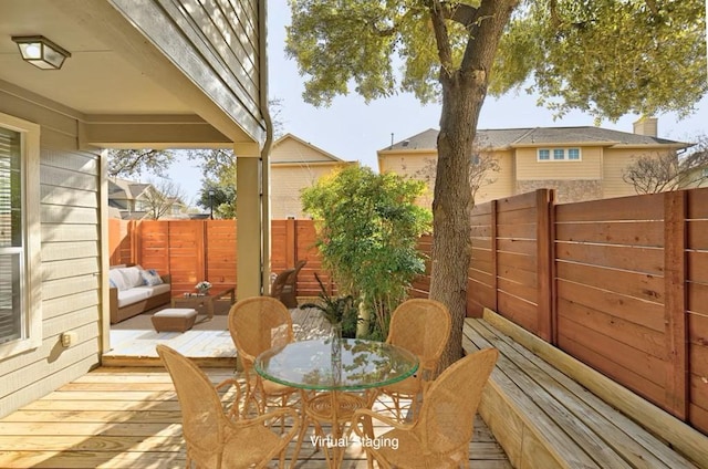 wooden deck with outdoor dining area and fence