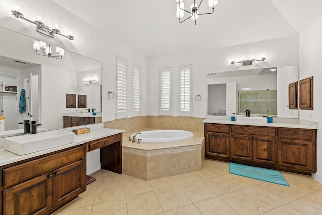 bathroom featuring a garden tub, an inviting chandelier, a sink, and a shower stall