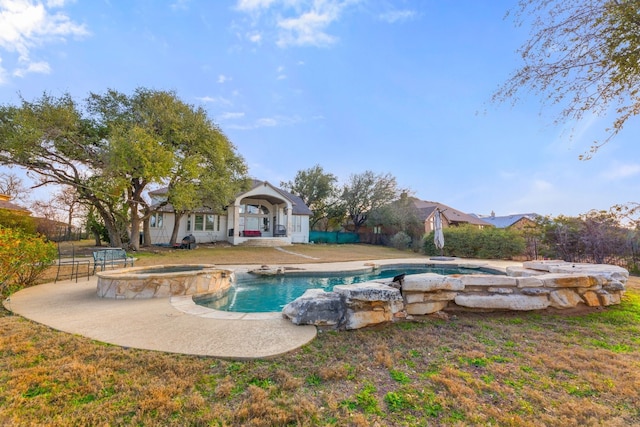 view of pool featuring a pool with connected hot tub and a patio