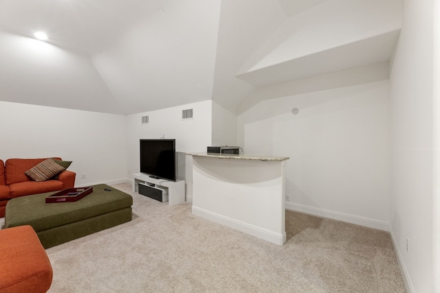 living room featuring vaulted ceiling, baseboards, visible vents, and light colored carpet