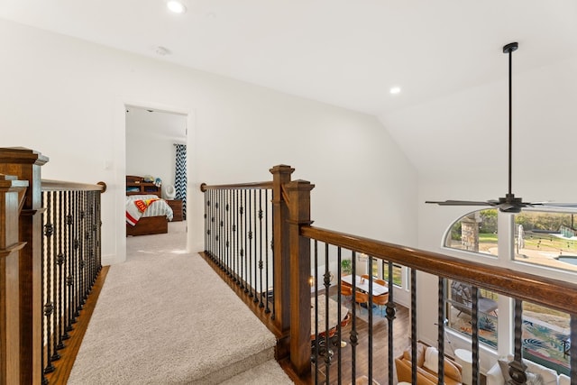 hallway with lofted ceiling, carpet, an upstairs landing, and recessed lighting