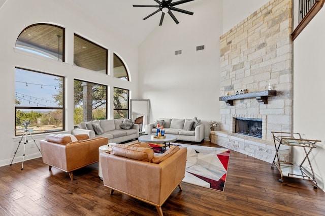 living area featuring a fireplace, dark wood finished floors, and visible vents