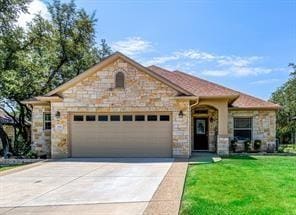 view of front facade featuring stone siding, concrete driveway, a front lawn, and an attached garage