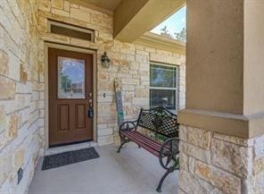 entrance to property with stone siding